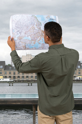 A man holding a map over his head