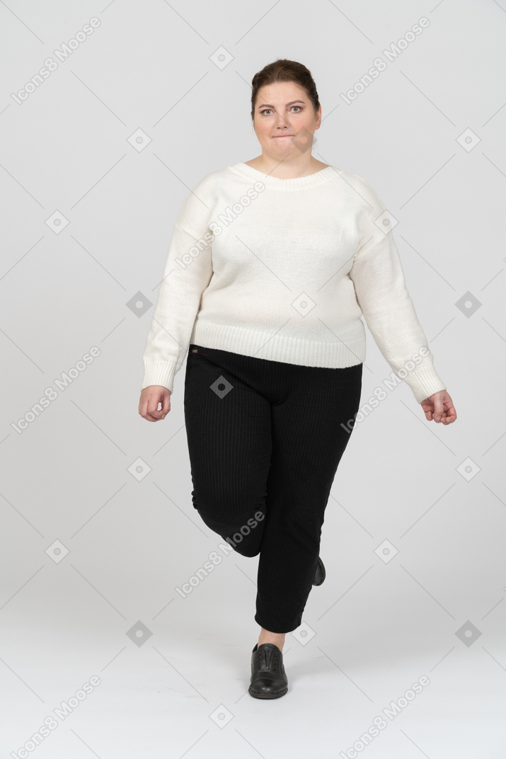 Plump woman in casual clothes biting her lip