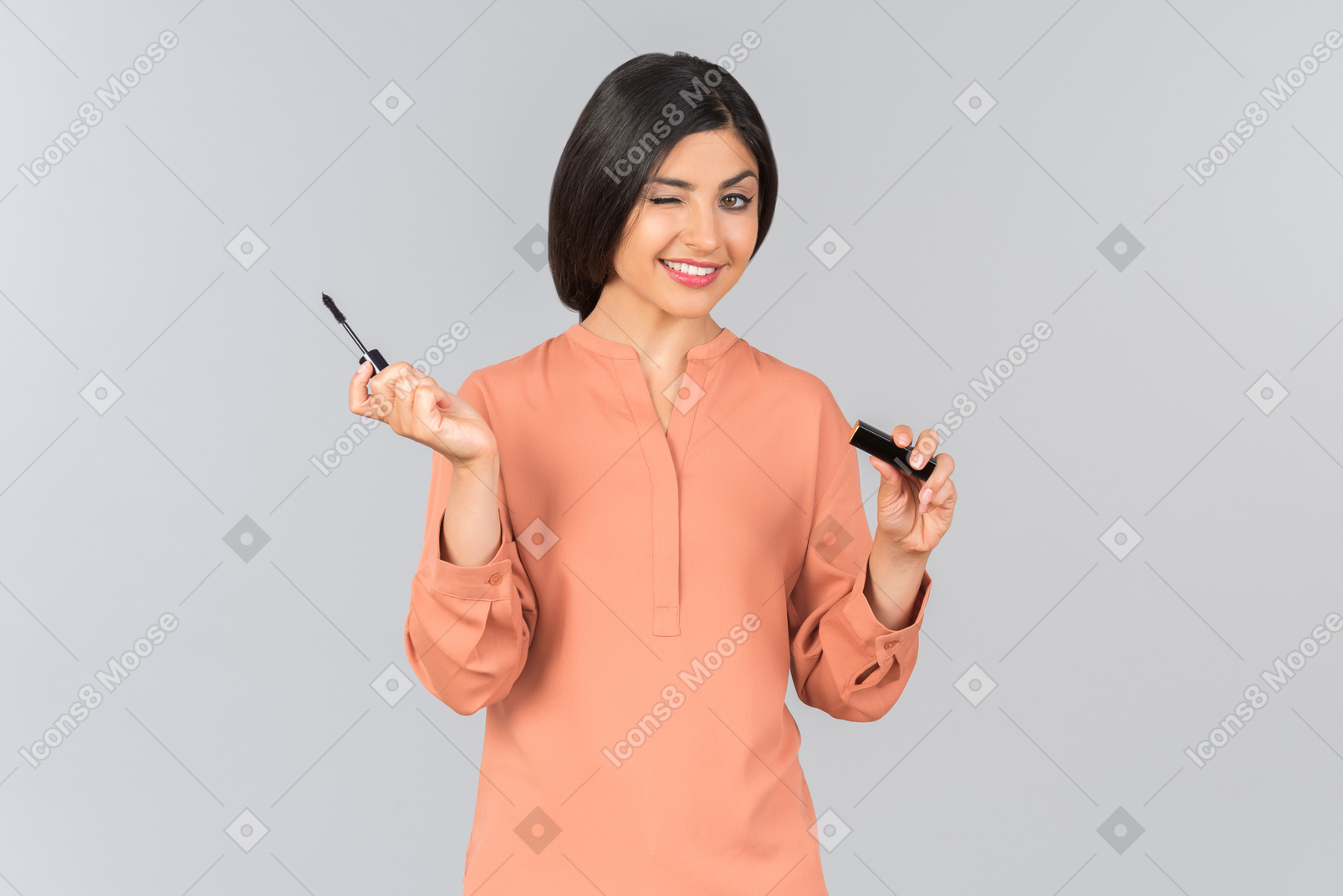 Indian girl applying mascara and winking