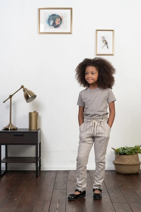 Good looking girl kid posing on the apartment background