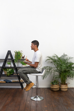 Good looking young man sitting on a chair