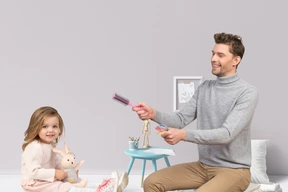 A man playing with a little girl
