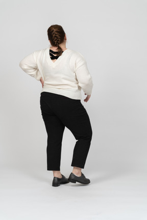 Rear view of a plump woman in casual clothes