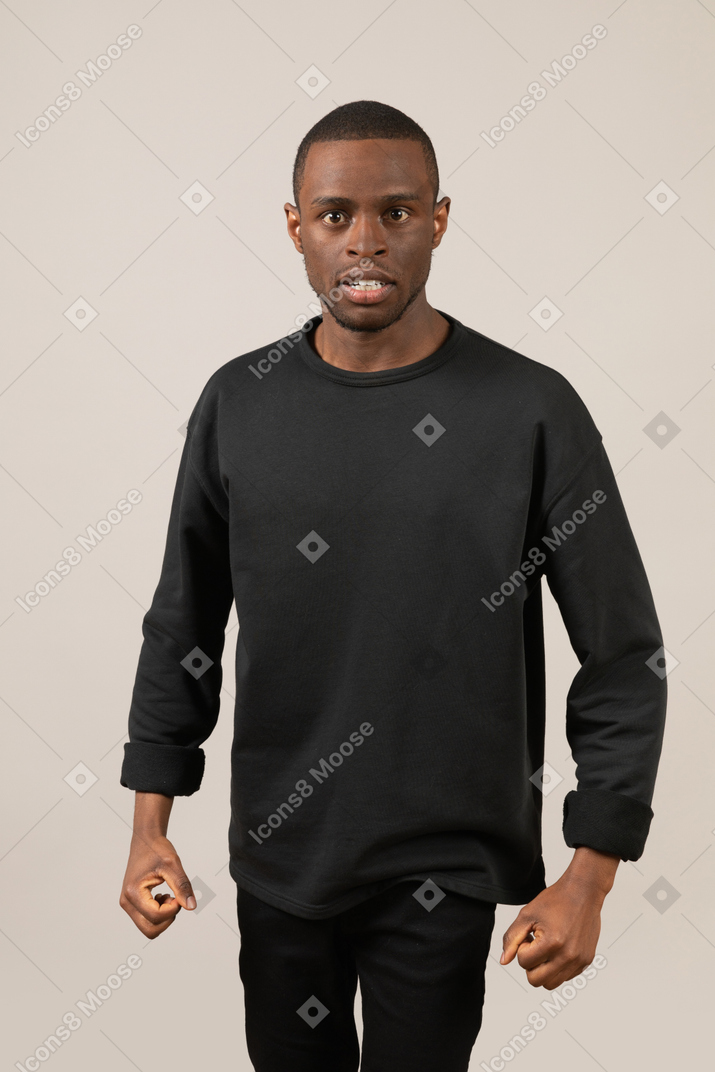 Man standing with clenched fists and teeth