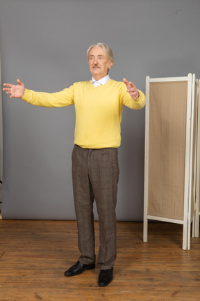 Three-quarter view of an old man outspreading his hands