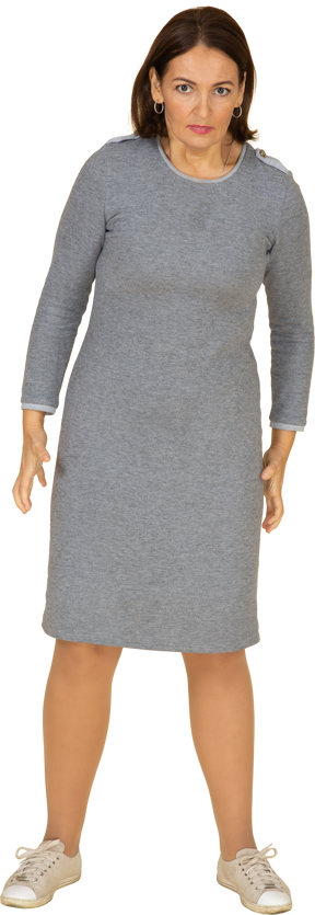 Front view of an angry woman in grey dress
