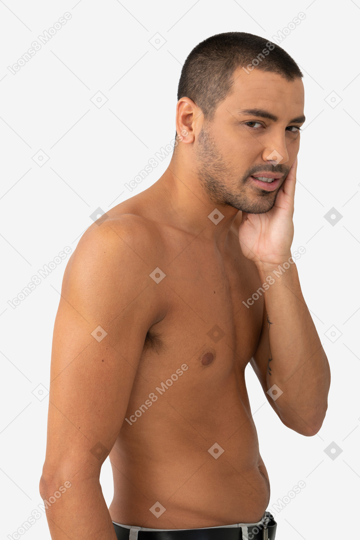 Barechested young man is looking tired