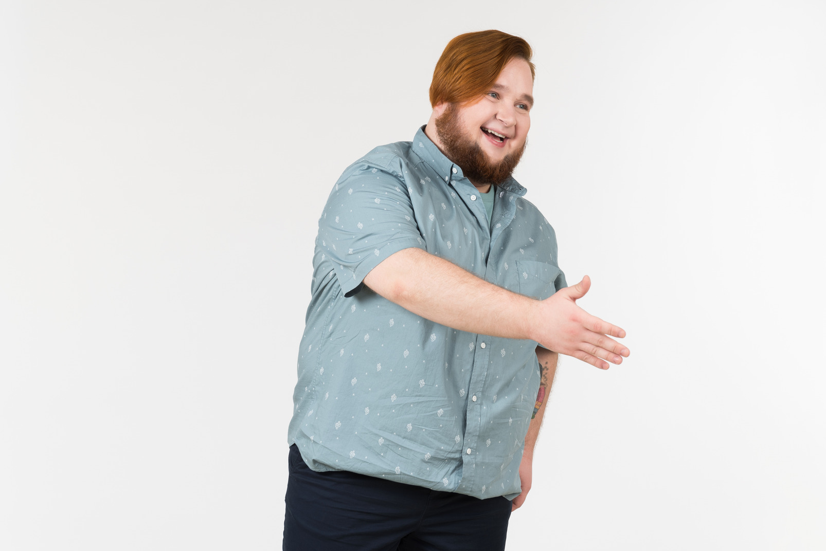 A fat man offering his hand to someone and smiling widely