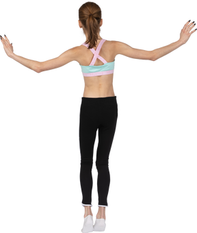 Vista traseira de uma adolescente em roupas esportivas, equilibrando-se na ponta dos pés enquanto levanta as mãos