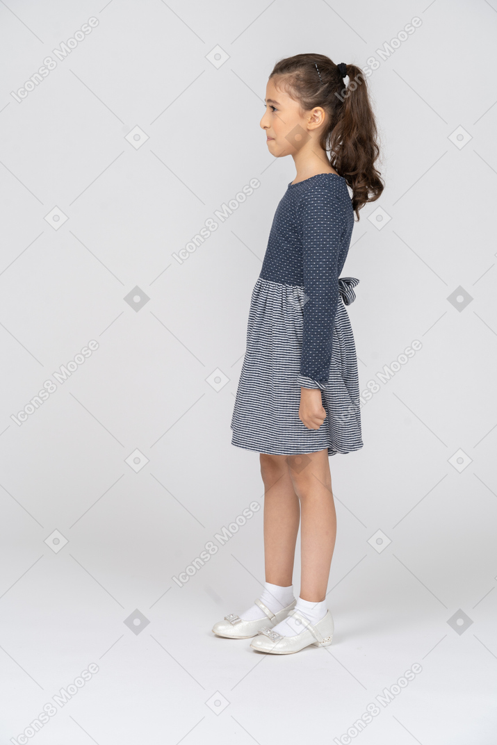 Side view of a girl suppressing a smile