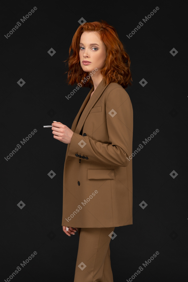 Attractive businesswoman posing with cigarette