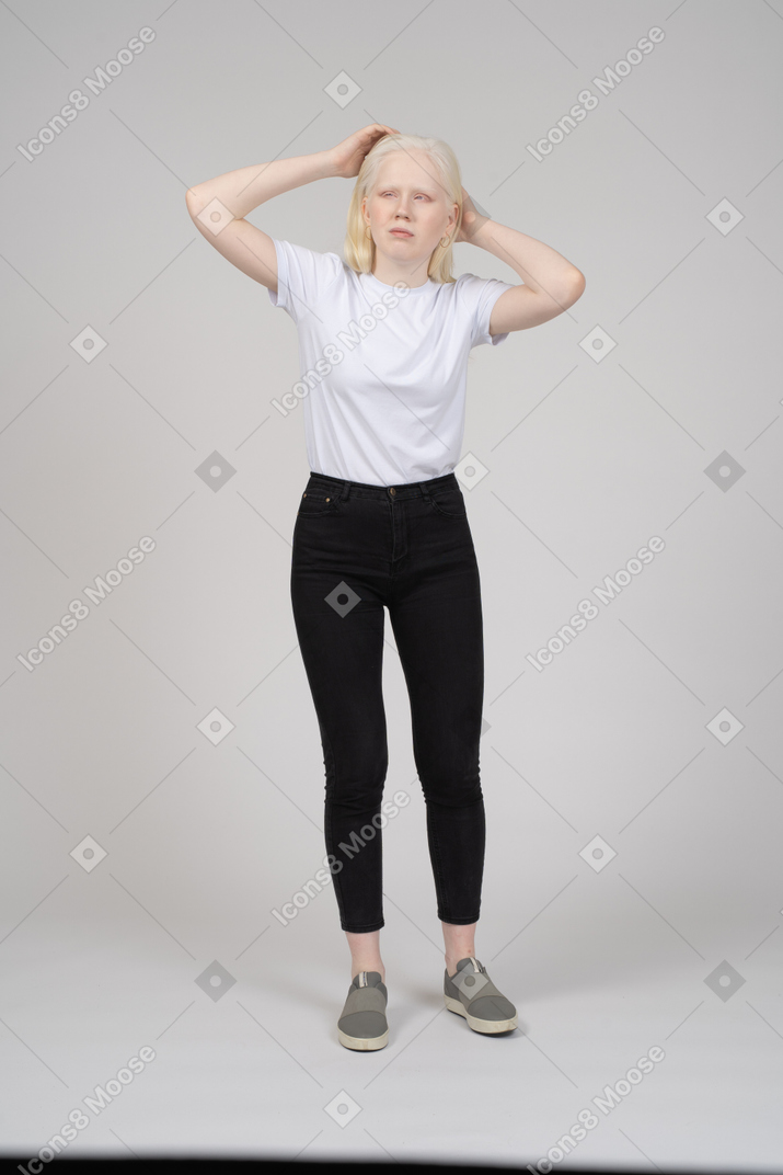Girl fixing hair with both hands
