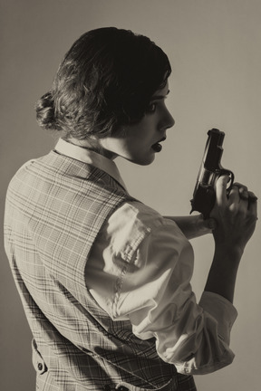 Female detective with a gun in profile