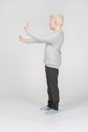 Little boy with both arms outstretched