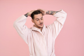 Attractive young man adjusting his hair