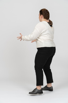 Plump woman in casual clothes standing