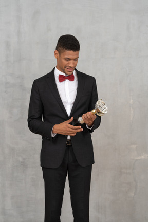 Smiling man in a suit holding an award