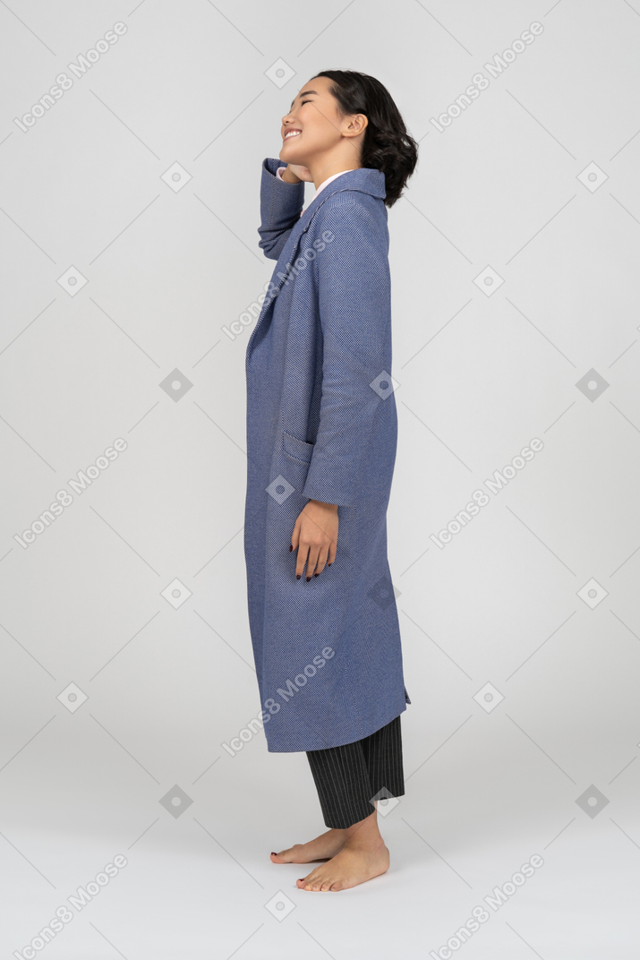 一个穿着外套的开朗女人的侧视图
