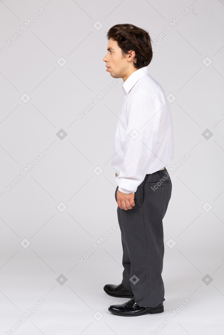 Vista lateral de um trabalhador de escritório masculino surpreso olhando para longe