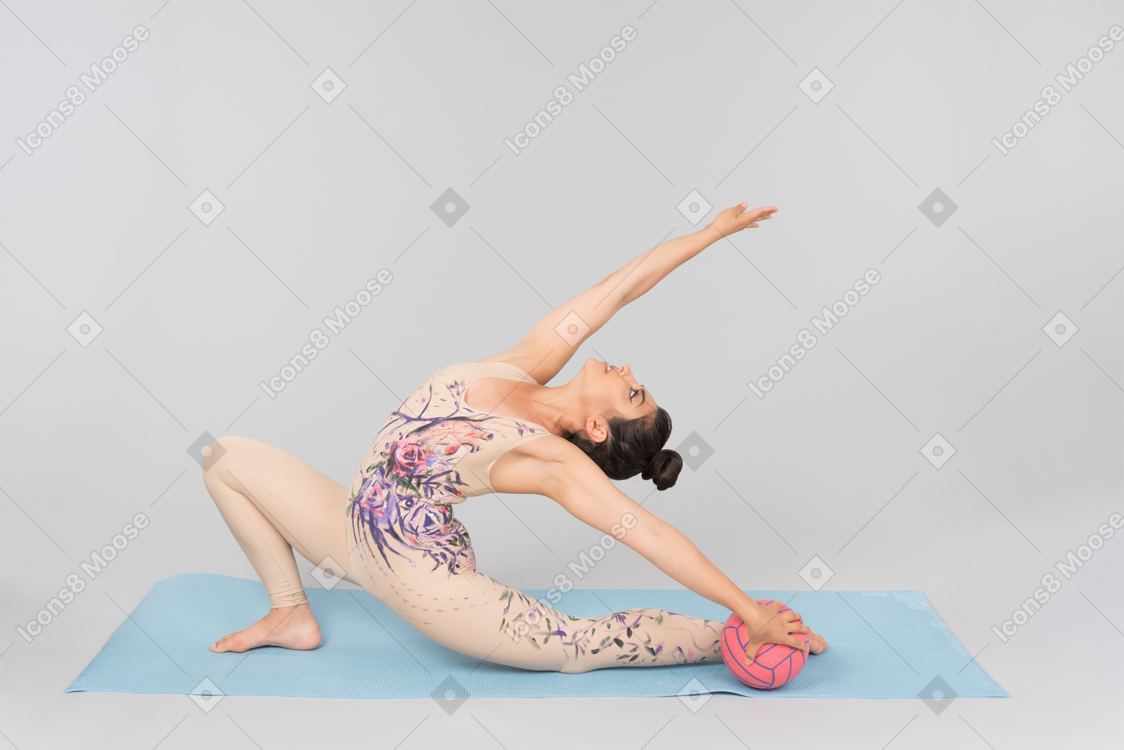 Young indian gymnast stretching herself sitting on yoga mat