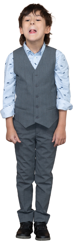 Front view  of a cute boy in grey suit showing tongue