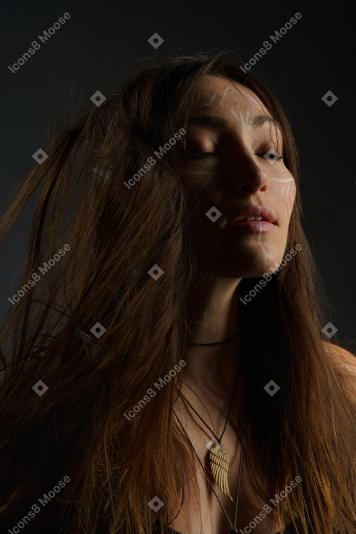 A woman with long brown hair and a necklace