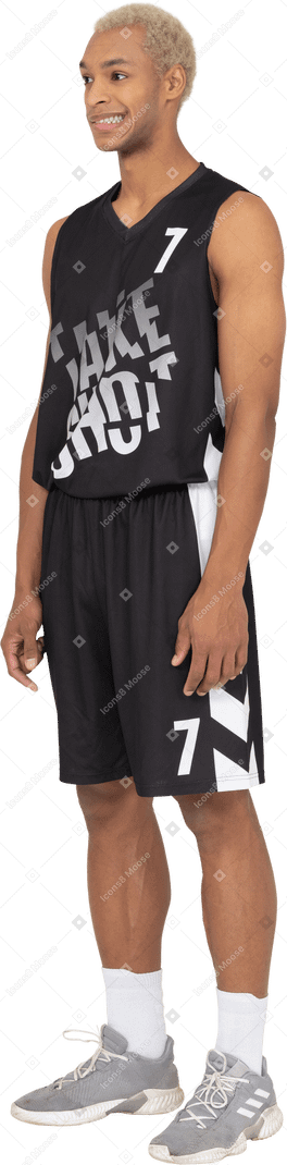 Three-quarter view of a confused young male basketball player standing still