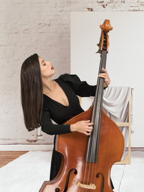 A woman playing on a cello