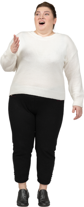 Impressed plump woman in casual clothes