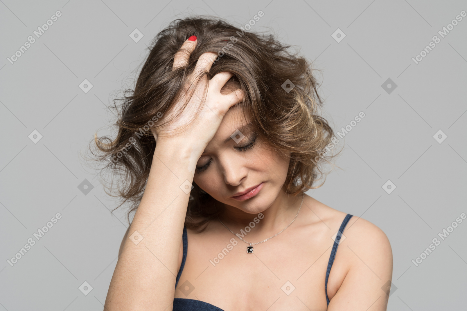 Concerned woman thinking about life and touching hair