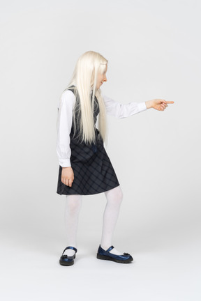 Schoolgirl pointing sideways