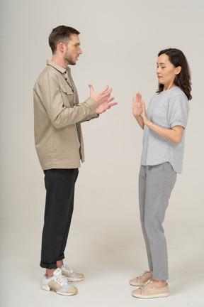 Side view of young couple speaking to each other