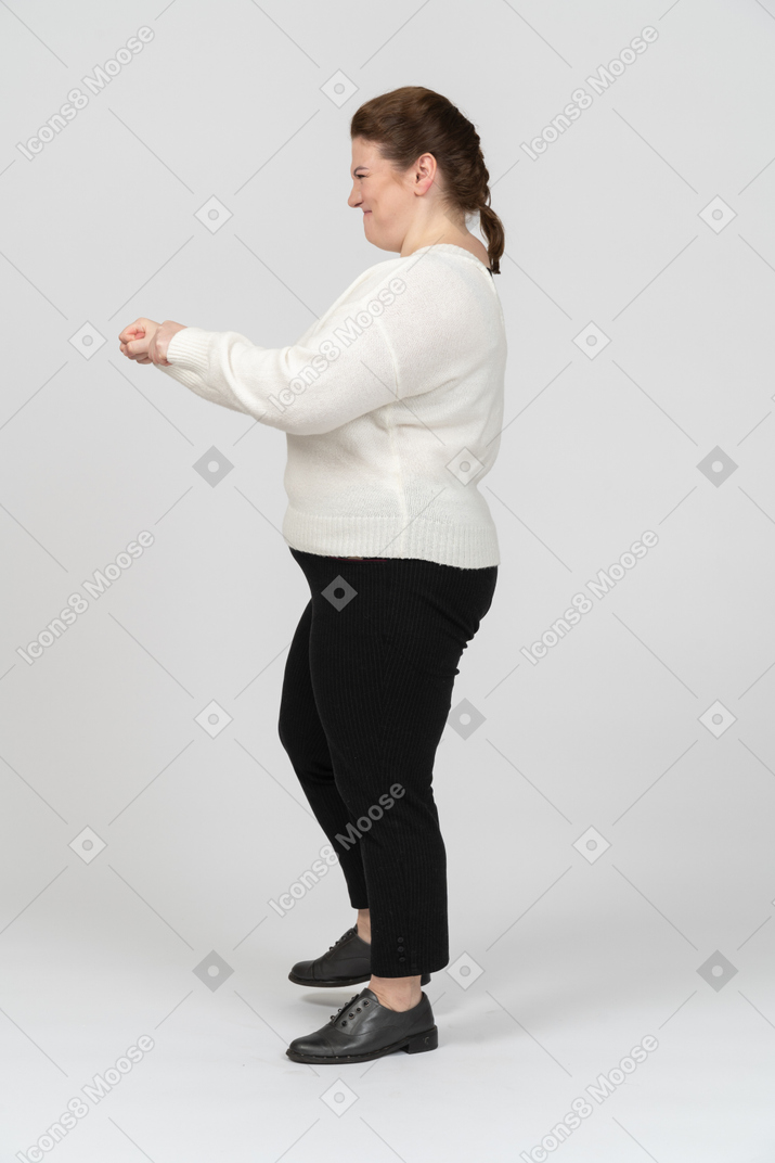 Plus size woman in white shirt posing
