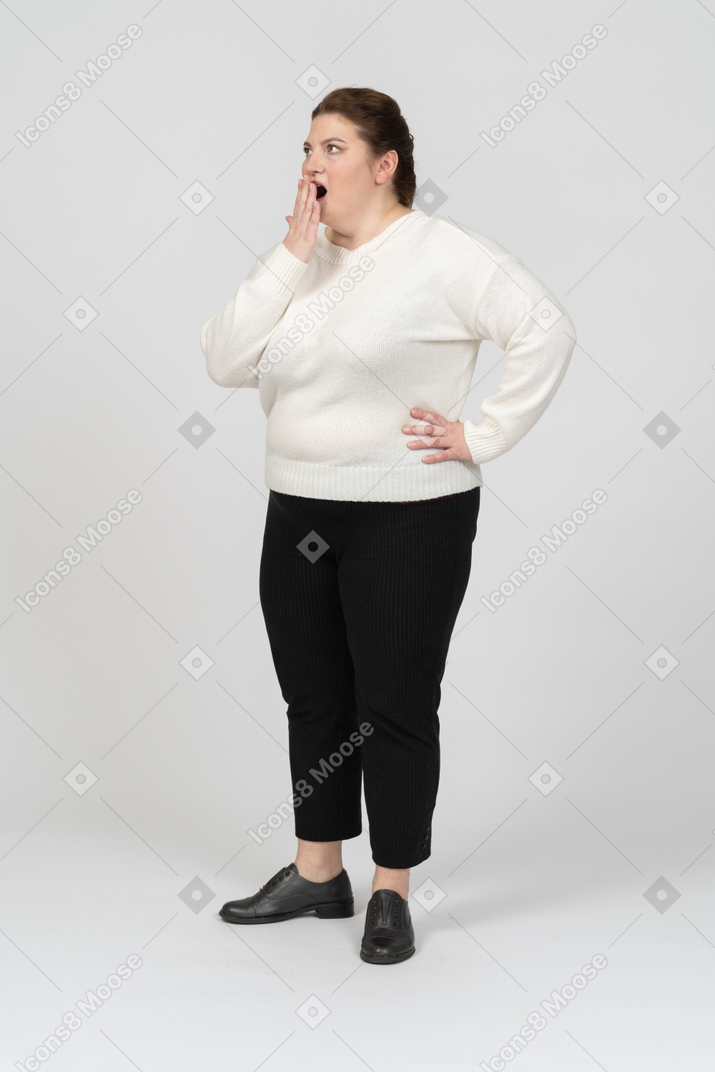 Impressed plump woman standing in profile