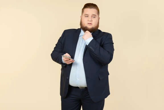 Twice the Man, Half the Size. Studio Shot of an Overweight Man Wearing Badly  Fitting Clothing. Stock Photo - Image of indoors, quirky: 256880944