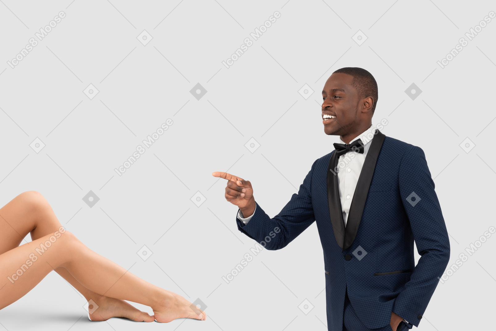 A man in a tuxedo pointing at a woman's legs