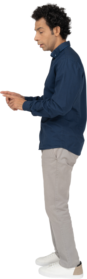 Side view of a man in casual clothes gesturing