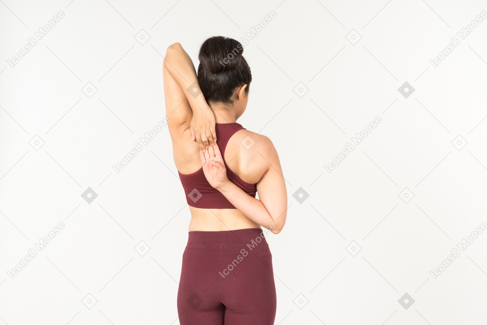 Young indian woman in sportswear holding hands crossed behind the back