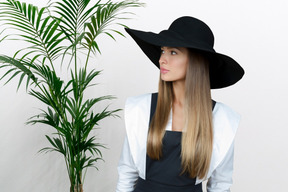 A woman with long hair wearing a black hat