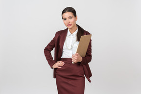 Attractive formally dressed woman holding a clipboard