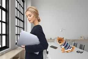 Woman with laptop and small dog in office space
