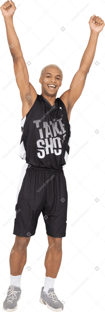 Front view of a happy young male basketball player raising hands