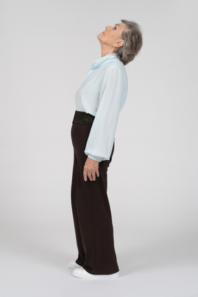 Side view of old woman leaning backwards