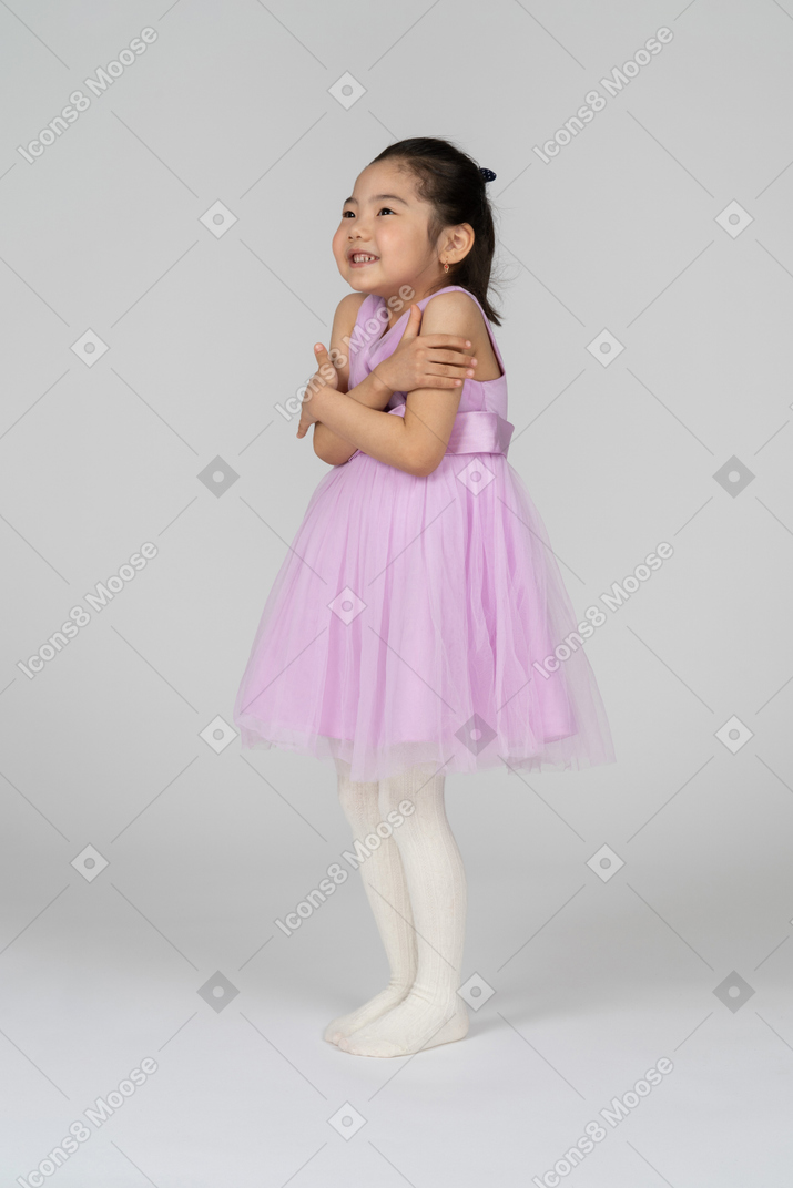 Portrait of a little girl shivering in a pretty dress