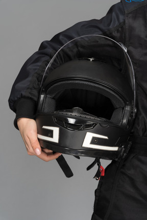 A black helmet in a female`s hand