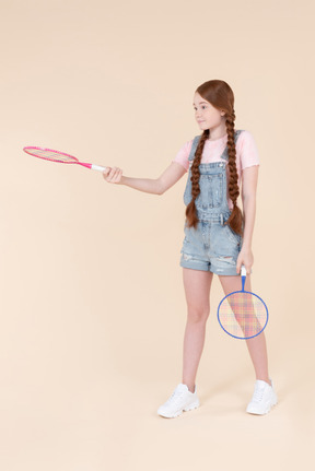 Teenage girl handling tennis racket she's holding