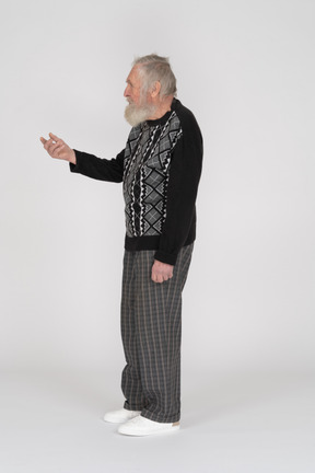 Side view of an elderly man gesturing and asking for something