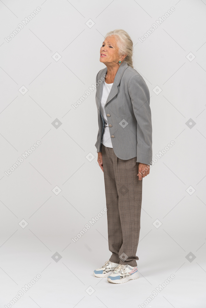 Sad old lady in suit standing in profile