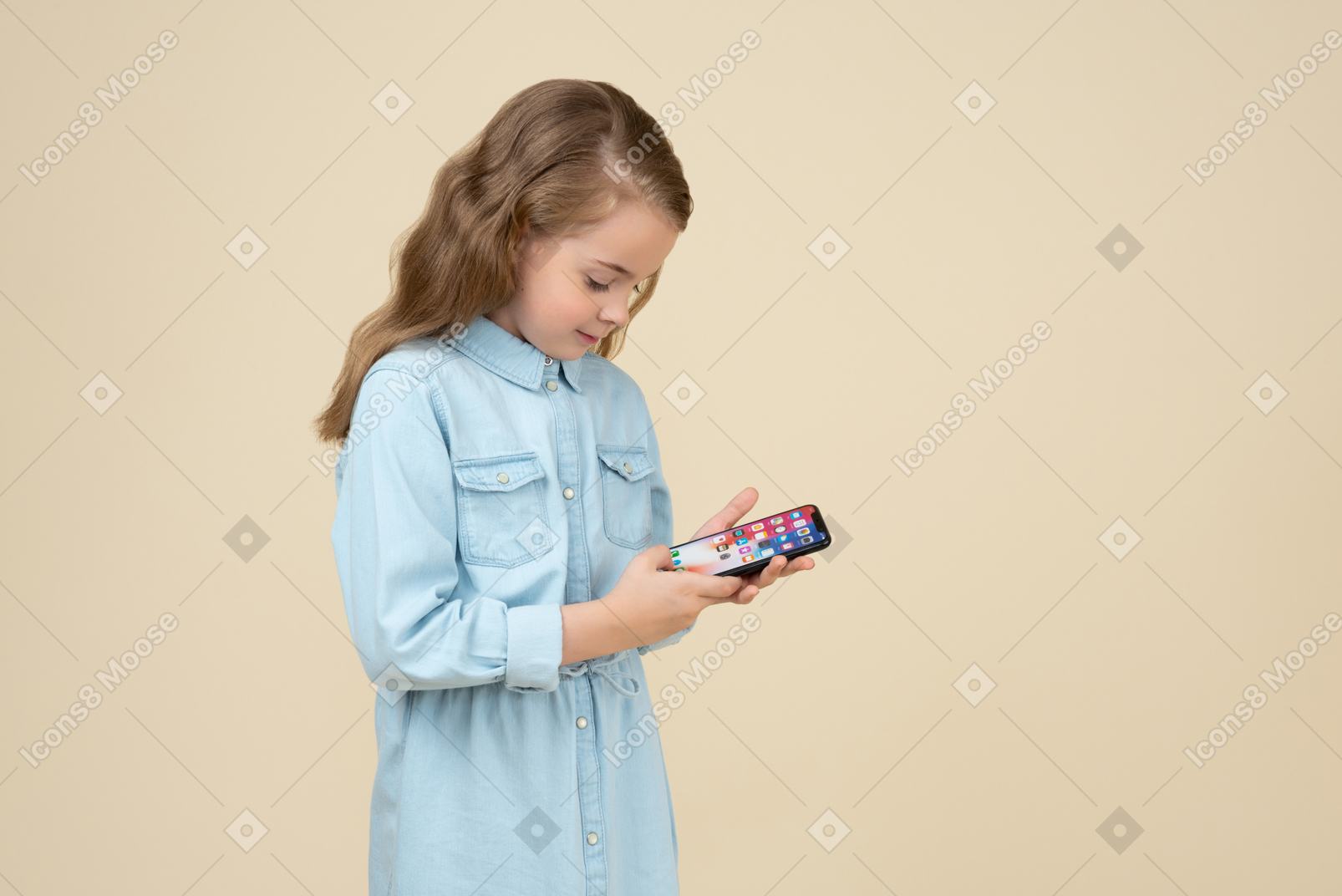 Cute little girl looking at the screen of her smartphone