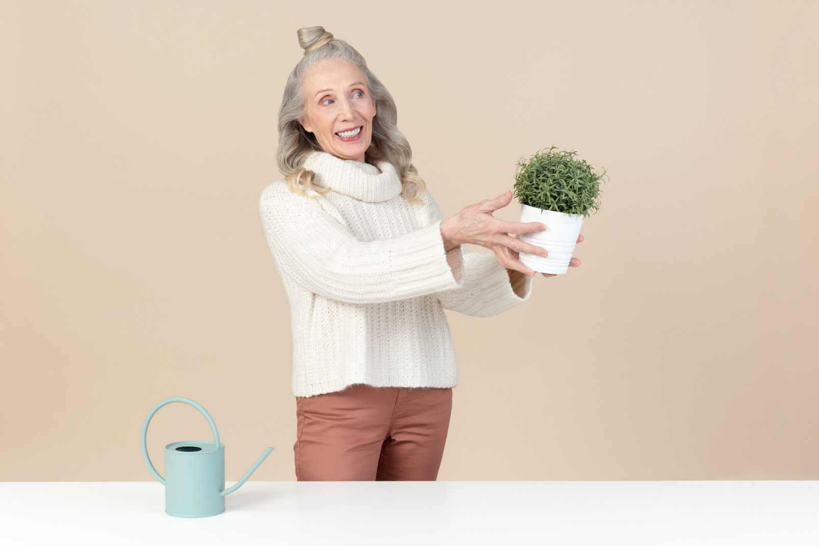 Old woman holding a plant